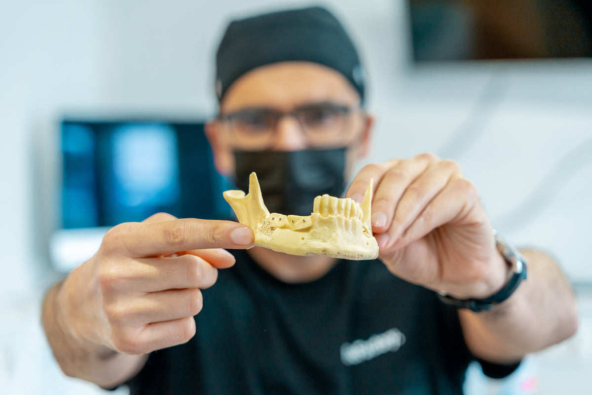 Şerif Küçük holding a mandible model